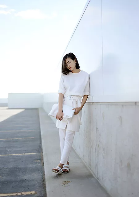 Модель в брюках-юбке молочного цвета, белая футболка