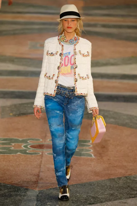 Модель в джинсах, футболке и жакете на показе Chanel Cruise в Гаване