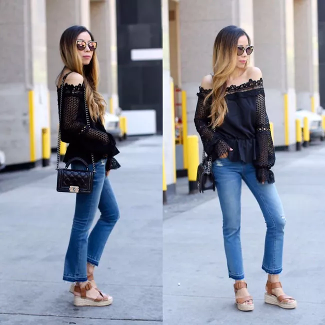 Девушка в укороченных джинсах и черной блузке