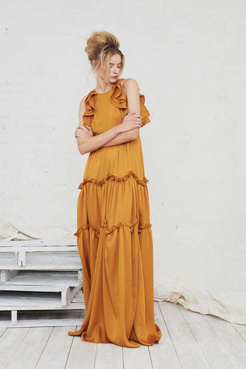 Модель в оранжевом платье в пол с рюшами от Marissa Webb