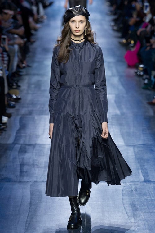 Модель в темно синем платье с рукавами и ниже колен от Christian Dior