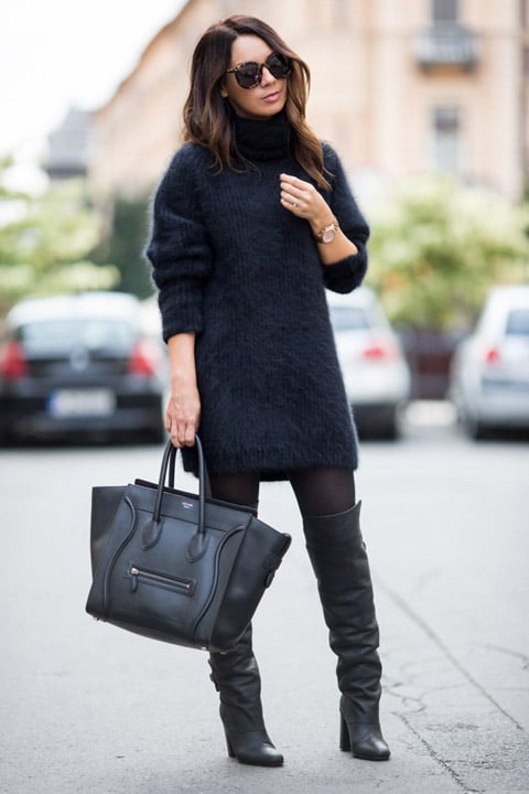 Девушка в черных высоких сапогах, мягкий удлиненный свитер и черня большая сумка
