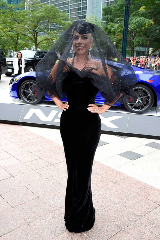 Леди Гага в черном облегающем платье и шлапка с вуалью