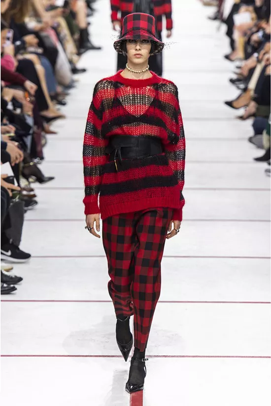 Модель в брюках в клетку, красно-черный свитер и черные туфли