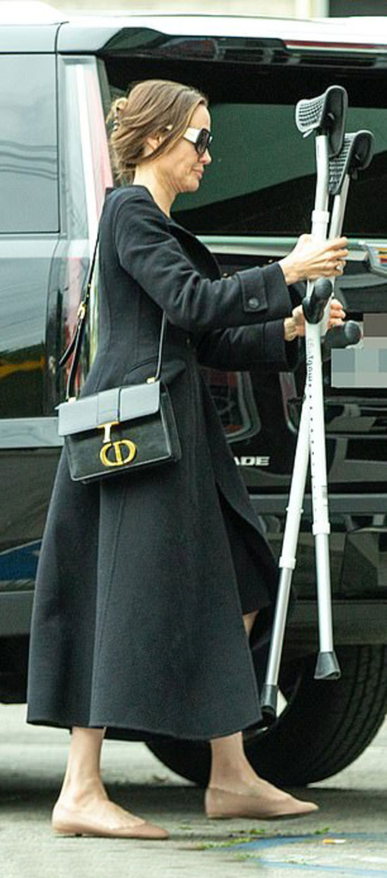 Анджелина Джоли в черном платье-миди, пальто и с дорогой сумкой