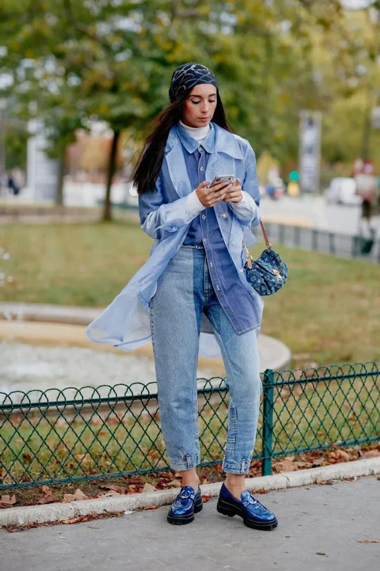 Девушка в полностью джинсовом образе со штанами, рубашкой и плащом, образ дополняют синие лакированные лоферы на платформе
