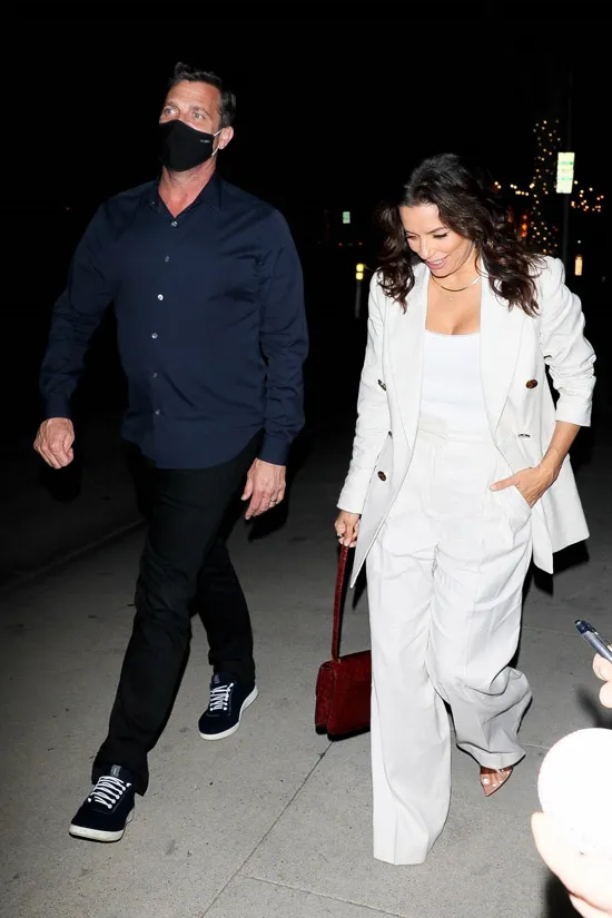 Ева Лонгория в белом пиджаке и с бордовой сумочкой