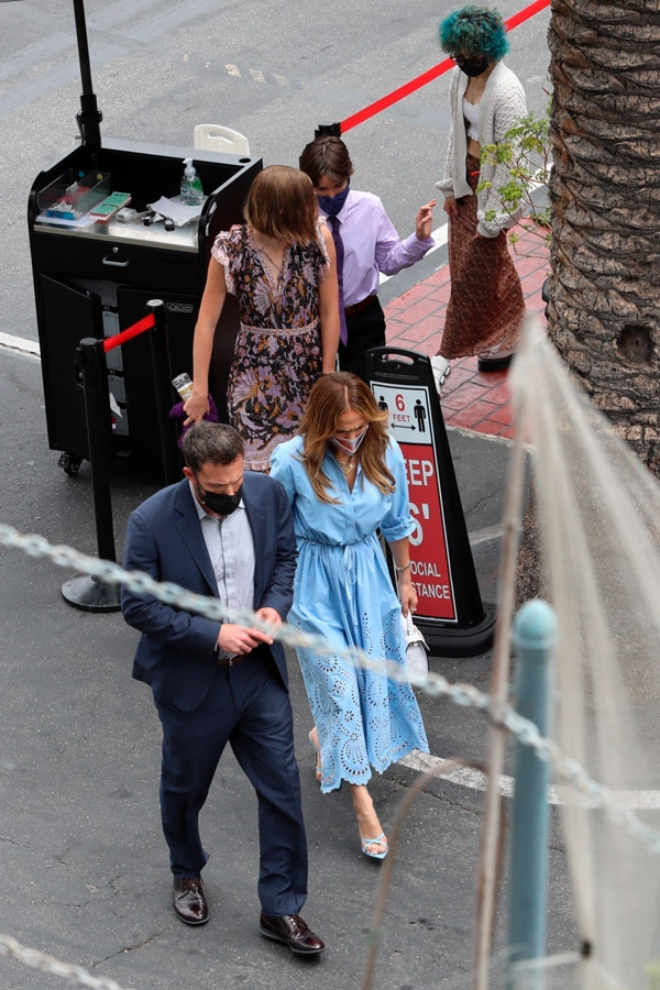 Дженнифер Лопес в синем платье и с белой сумкой