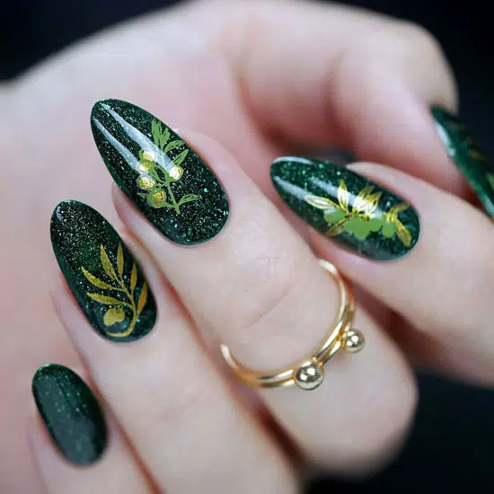 Черный маникюр с блестками и растительным принтом на овальных ногтях средней длины