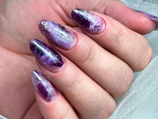 Необычный фиолетовый маникюр с блестками на овальных ногтях