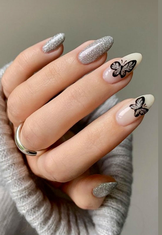 Серебристый маникюр с бабочками на острых ногтях средней длины