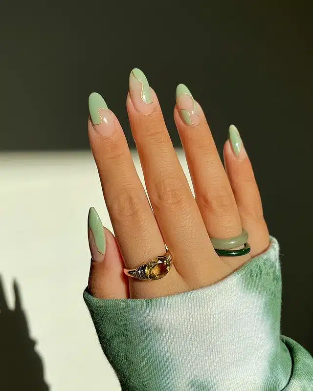 Волнистый зеленый маникюр с золотыми линиям на длинных ногтях