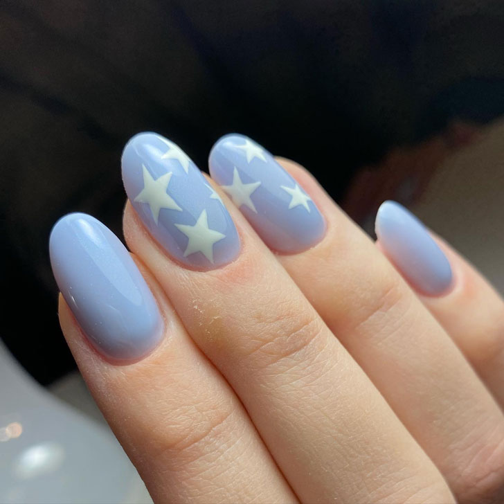 Голубой маникюр со звездами на овальных ногтях средней длины