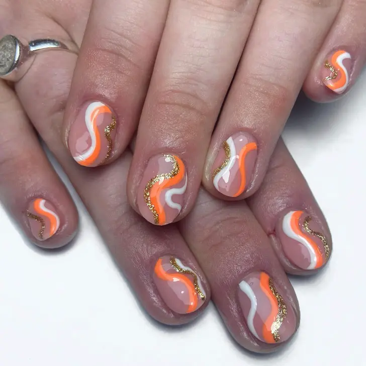 Маникюр с оранжевыми и золотыми волнами на овальных коротких ногтях