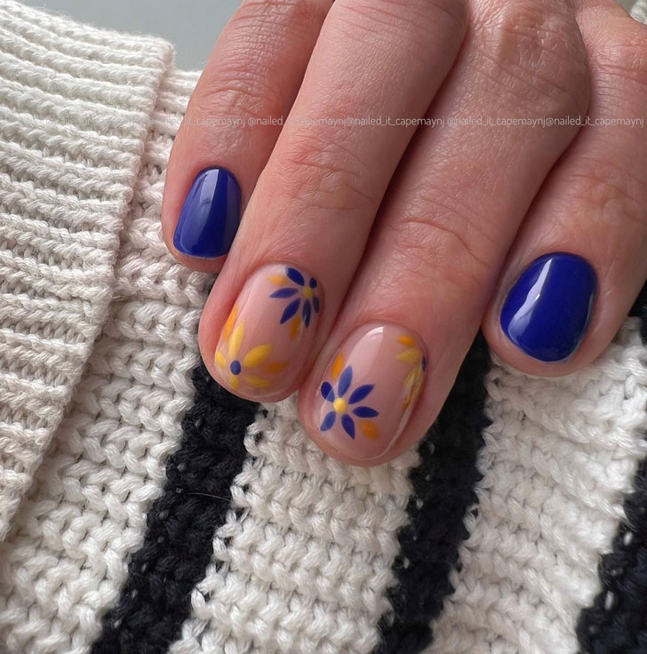 Синий маникюр с желтыми цветами на коротких ухоженных ногтях