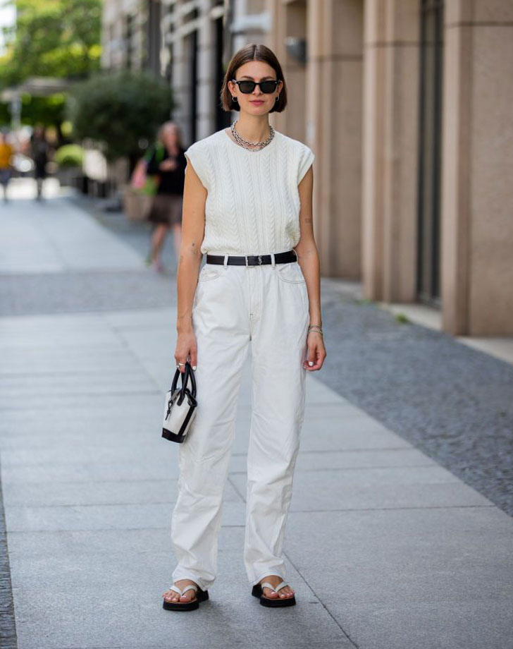Девушка в белых прямых брюках с ремнем и белом топе
