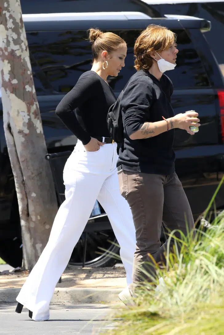 Дженнифер Лопес в белых длинных джинсах, черных босоножках и сдержанной прической
