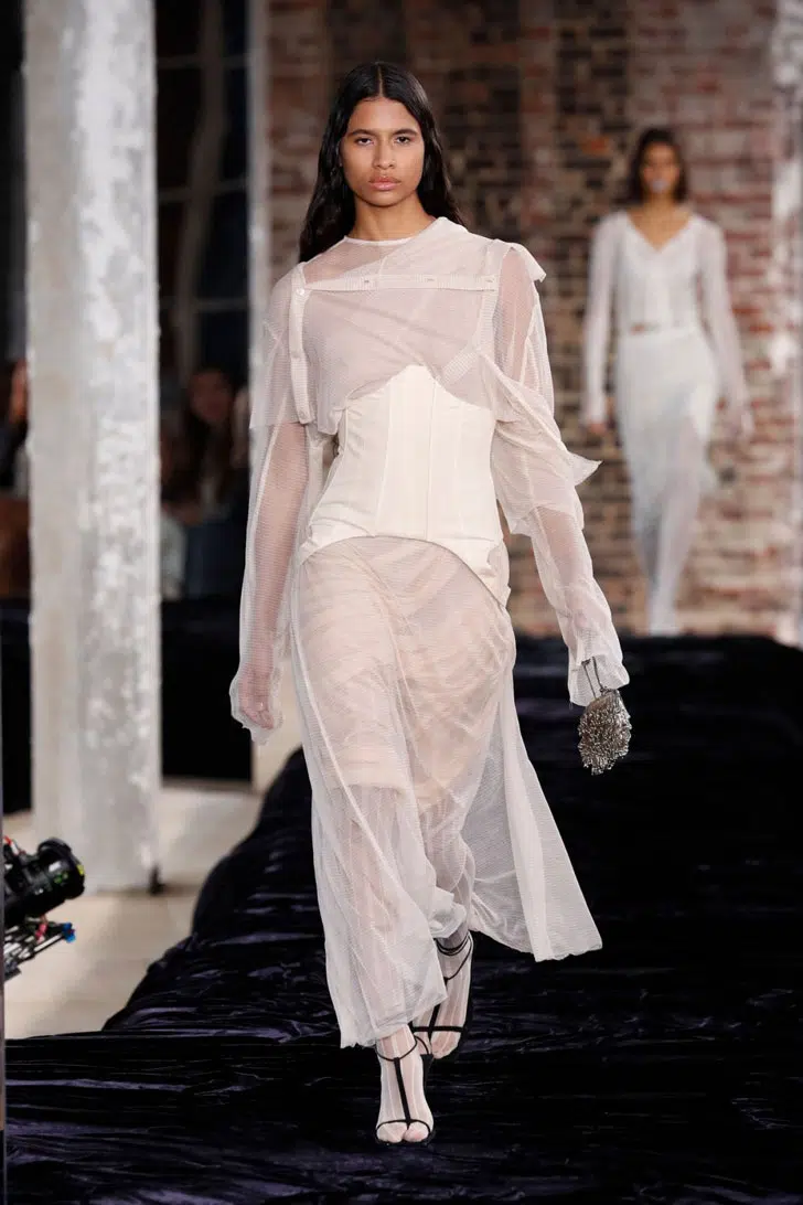Модель в платье бежевого цвета с корсетом от Acne Studios