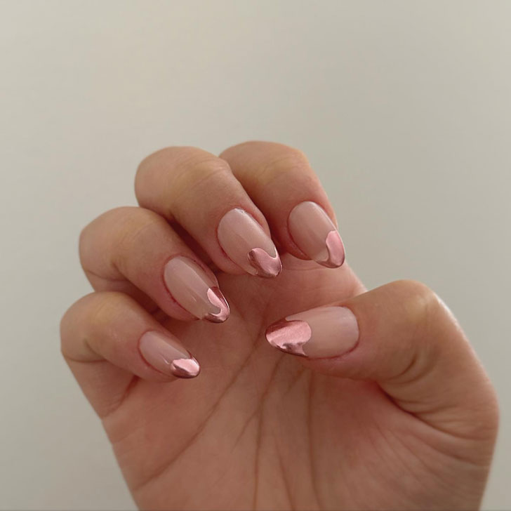 Pink jacket of the original form on well-groomed nails