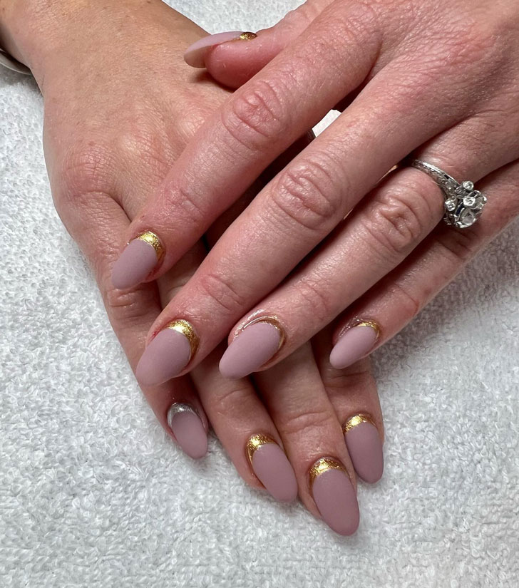 Golden moon manicure on a matte base and medium length oval nails