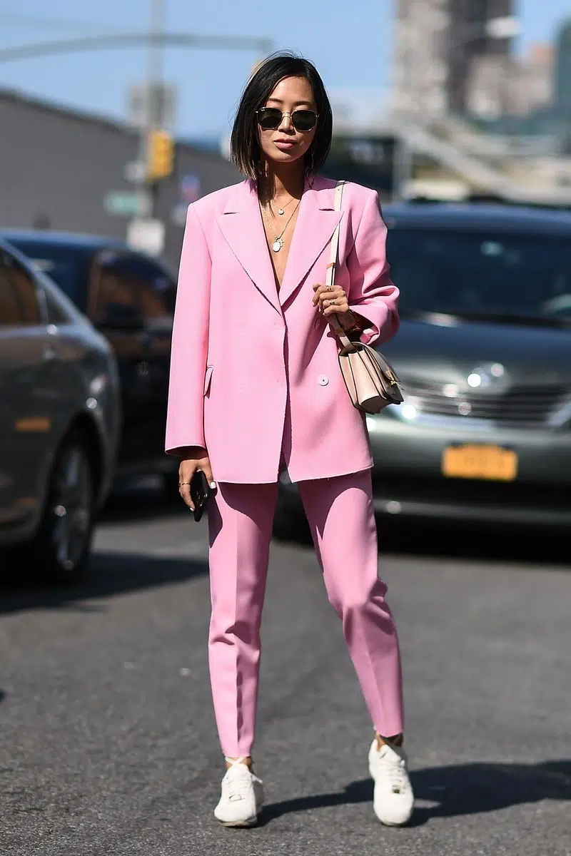 Девушка в розовом брючном костюме и кроссовках - 2017 год