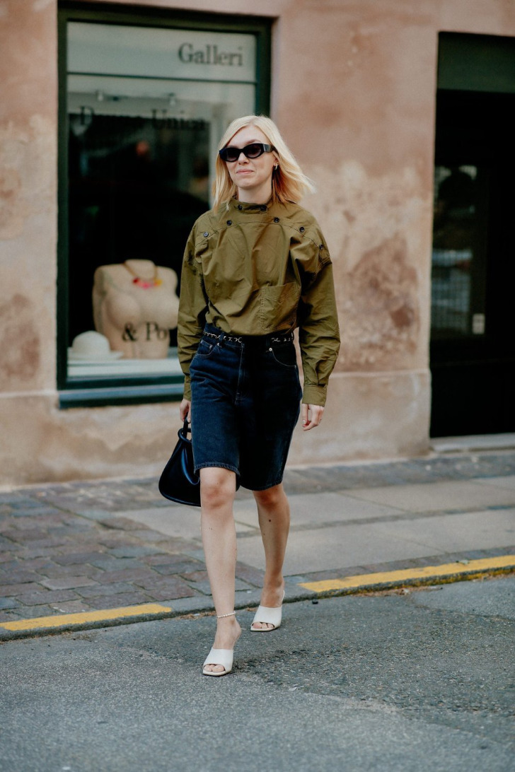 Женщина в босоножках цвета слоновой кости и джинсовых шортах