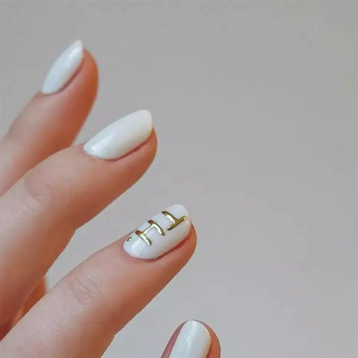 Белый маникюр с золотыми узорами на коротких натуральных ногтях