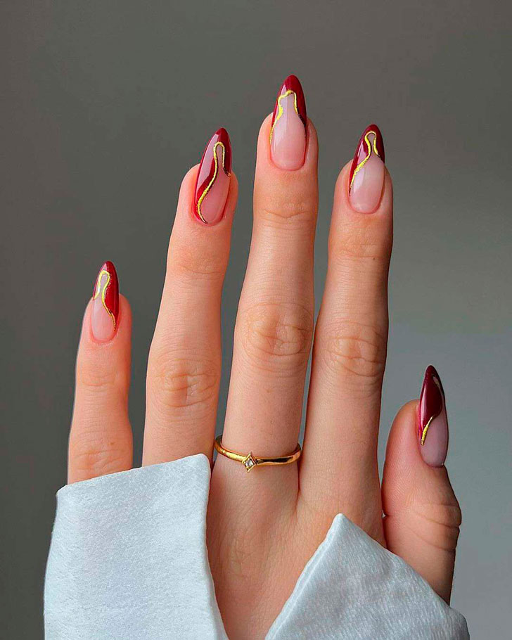 Бордовый абстрактный френч с золотой окантовкой на длинных миндальных ногтях